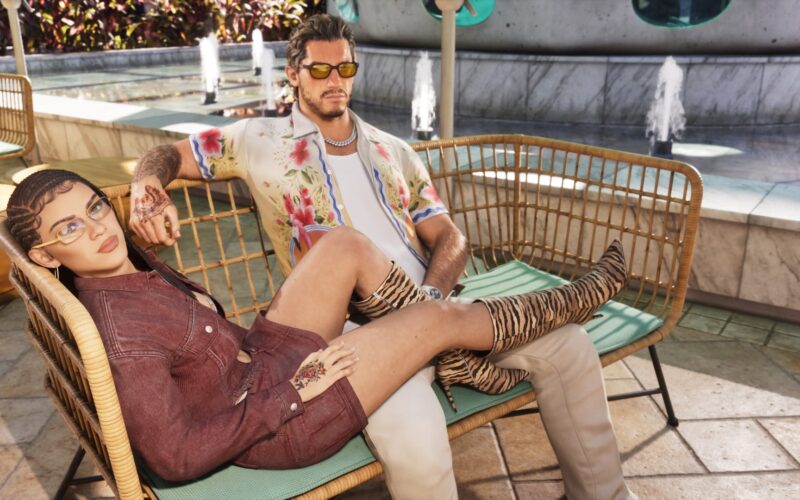 Official Grand Theft Auto VI image of Jason and Lucia relaxing on a rattan bench beside a fountain in Vice City