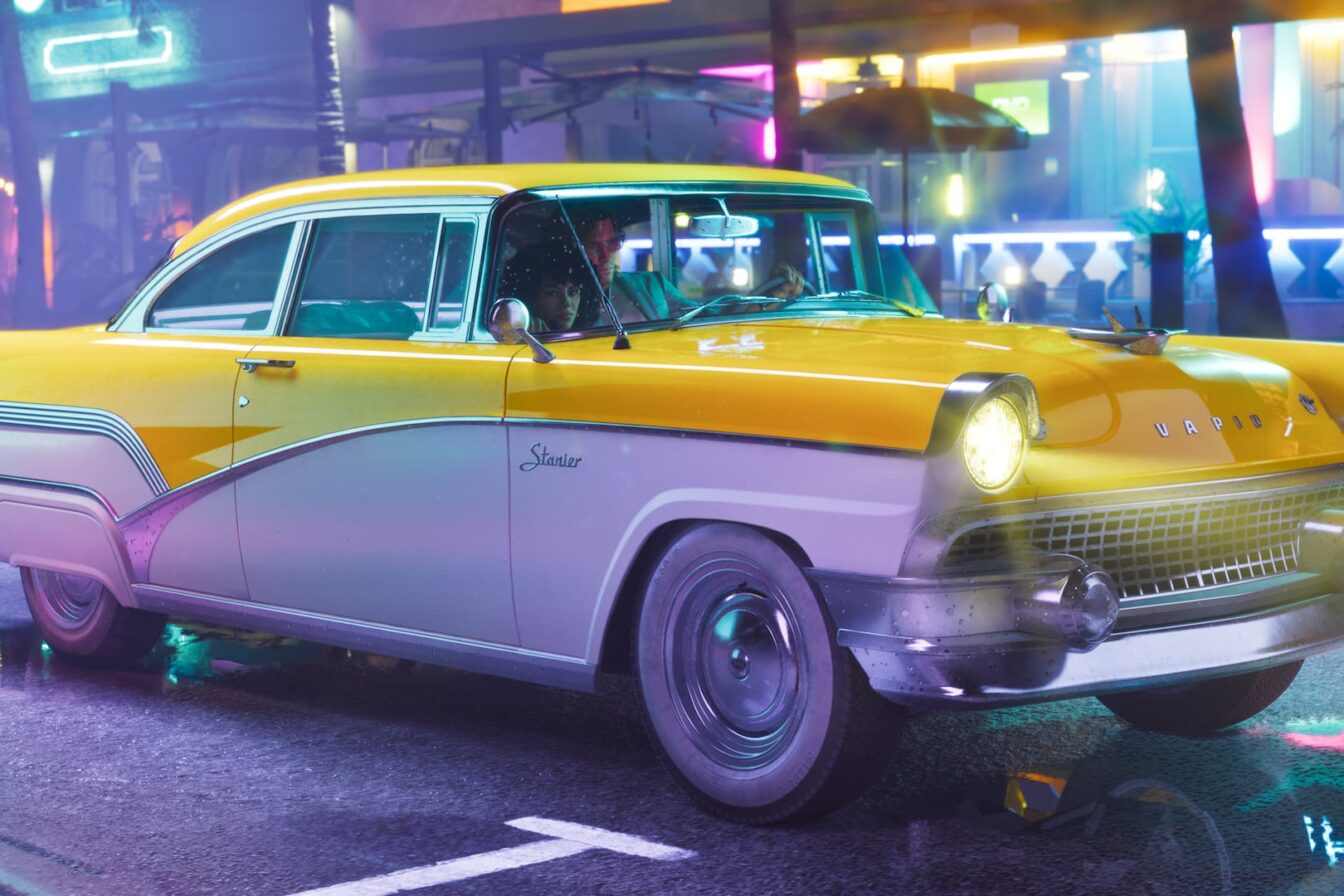 Official Grand Theft Auto VI image of a yellow and white Vapid Stanier with two people inside, driving down a neon-lit wet street
