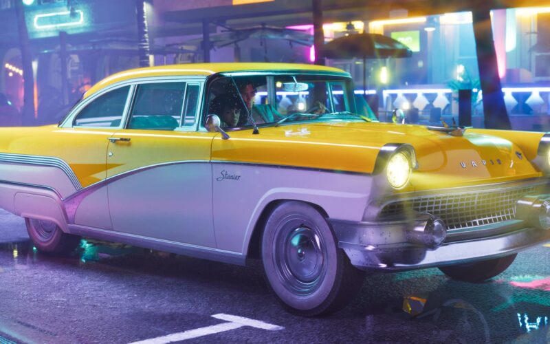 Official Grand Theft Auto VI image of a yellow and white Vapid Stanier with two people inside, driving down a neon-lit wet street