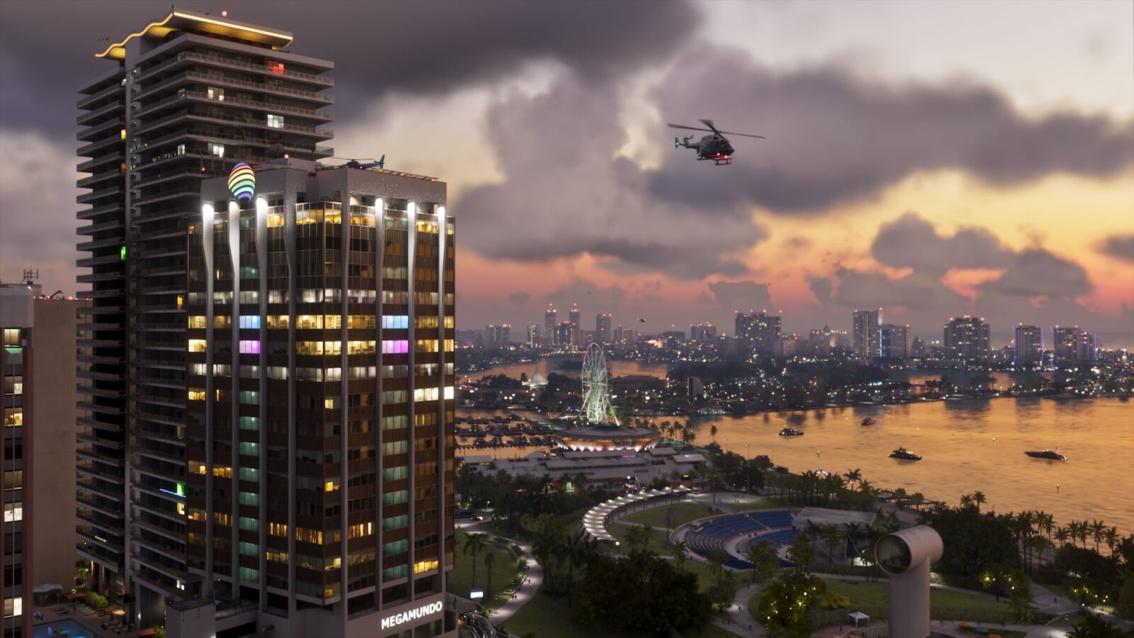 Official Grand Theft Auto VI screenshot of a Vice City waterfront at dusk, with a helicopter over a lit skyscraper and a Ferris wheel by the bay