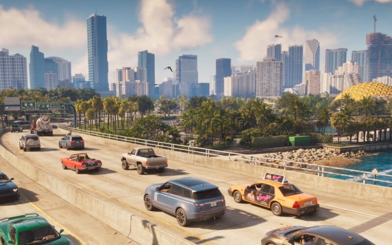 Official Grand Theft Auto VI screenshot of highway traffic with the Vice City skyline and a golden dome in the distance
